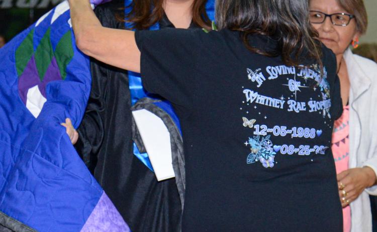 Waubay High School graduate Adryan Hopkins was presented with a quilt by grandmothers Estelle Hopkins and Beatrice Biddell after she received her diploma May 11. Reporter &amp; Farmer | Amanda Dulitz