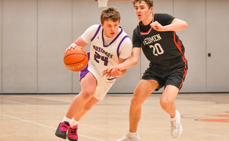 McKoy Pereboom (24) of Waubay/Summit drives the ball up court during the Mustangs narrow 45-46 loss to Sisseton Redmen Jan. 13 in Summit. Pereboom finished with three points and the Mustangs fall to a record of 3-4 on the season. Reporter &amp; Farmer | Leyton Beardslee
