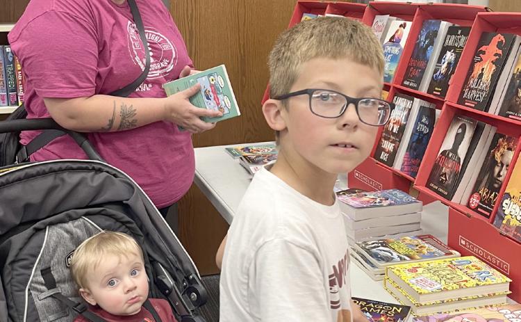 Webster Area School held a bookfair Oct. 7-10 along with parent/teacher conferences. The event helps raise money for the school’s libraries. Rachel Rolstad with Charlie Rolstad and Brayden Town enjoy looking through the selections. Reporter &amp; Farmer | Subscriber snapshot