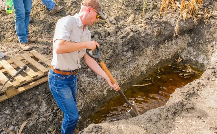 South Dakota state soil health specialist Kent Vlieger shows the water table and salinity level of the soil in a field south of Andover Sept. 29. The area falls in the James River Valley region which since the 1990s has seen an increase in saline affected soil. Reporter &amp; Farmer | Leyton Beardslee