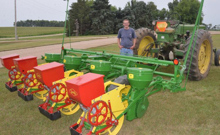 Fourth-generation Day County farmer Scott Hughes shows off his early ‘60s John Deere planter. Hughes completed the vintage planter’s restoration this June, a project he undertook after discovering the long-lost implement once belonged to his great-grandfather. Reporter &amp; Farmer | Timothy Gibson