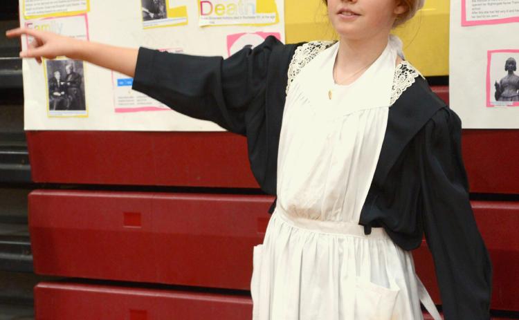 Members of Webster Area Elementary’s fifth grade class put on the annual living wax museum May 3 at Webster Armory. The event was open to the public to watch and listen to students tell about the historical character they had studied and were portraying. Shown here, Arianna Altstadt tells details of the life of Florence Nightingale. Reporter &amp; Farmer | Kole Rithmiller