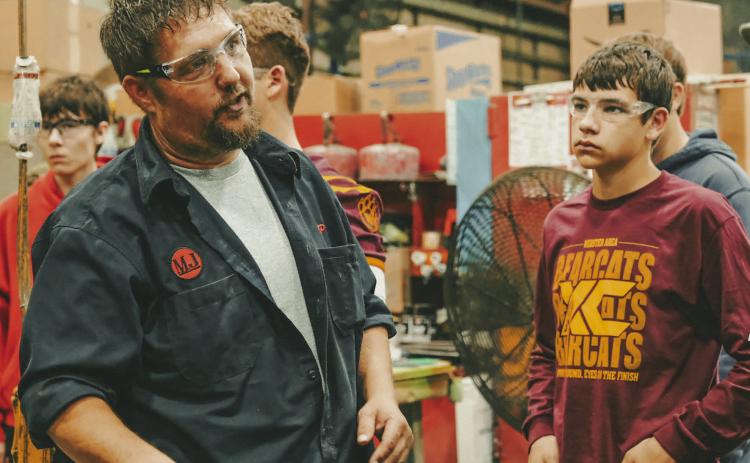 Webster Area High School freshman Mason Hauck, right, listens to Mereen-Johnson field service manager JP Vander Wilt, left, during a tour for high school students of the Mereen-Johnson’s facilities in Webster Oct. 3. Reporter &amp; Farmer | Leyton Beardslee