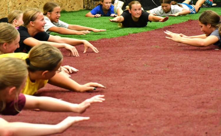 A performance camp was hosted for boys and girls July 27-30 at the baseball’s indoor complex. TLC Physical Therapy put on this camp as a way for kids to get more excercise and learn college level training techniques. “It’s been so fun so far, everyone seems to love it,” said Ayla Bloom. From left, Bloom, McKenley Curran, Harper Olson, Portlyn Johnson, Lydia Petersek, Embry Duenwald, Elin Voss and Ryan Johnson hold the “superman” pose. Reporter &amp; Farmer | Connor Handrahan