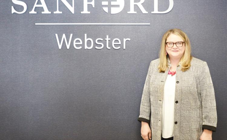 Melissa Cunningham was hired as the new CEO for Sanford Health and Bethesda Home in Webster Nov. 4. Here, Cunningham stands next to the Sanford sign in the clinic. Reporter &amp; Farmer | Brenner Cariveau