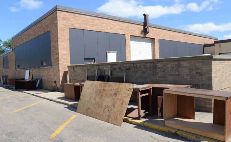 North of Webster Area High School July 17 sits surplus items as the north wing of the school will be demolished later this fall.