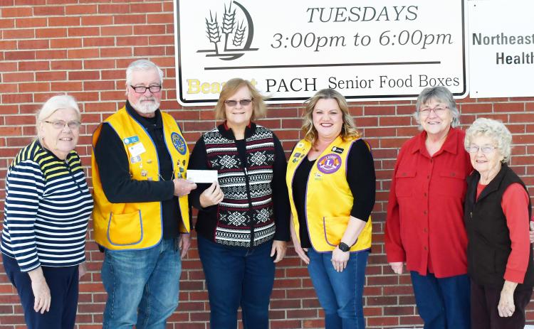 Eden Lions Club donated a check for $500 to the Day County Food Pantry Dec. 3. Pictured from left, Winnie Jacobs Day County Food Pantry volunteer, Dan Poss president of the Eden Lions Club, Margaret Kwasniewski Day County Food Pantry volunteer, Jannine Fagerland secretary of the Eden Lions Club, Mary Wagner and Carol Richardt Day County Food Pantry volunteers, stand in front of the Day County Food Pantry sign. Reporter &amp; Farmer | Brenner Cariveau