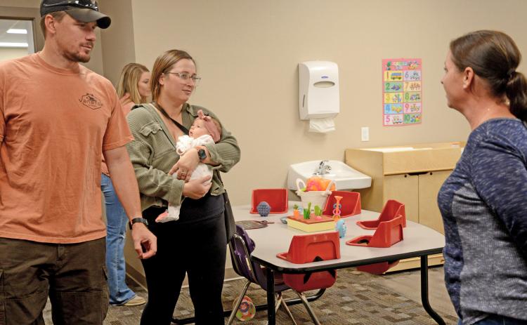 Jacob and Katlyn Lorton of Webster, along with seven-week-old daughter Maggie, listen to Knapp & Play child care expert Katy Sattler explain about the infant room practices and procedures during the center’s community open house event Sept. 3. The first-time parents were planning to bring their child to the center and were there to check out the newly renovated space. Staff were prepared to begin taking in children by Sept. 8, as of press deadline. The Knapp & Play Learning Center will have the capacity for