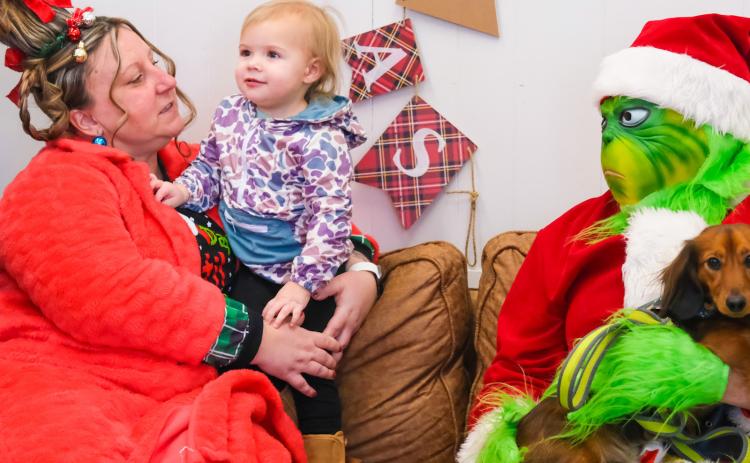 Piper Spears, age two, meets Cindy Lou Who played by Amanda Dohn, the Grinch, played by Tori Hoffer Dec. 13 at Brewhouse in Webster. The meet-and-greet was part of a fundraiser to cover medical expenses for a local child who experienced a medical trauma. Spears is the daughter of Megan and John Spears from Webster. Reporter &amp; Farmer | Leyton Beardslee