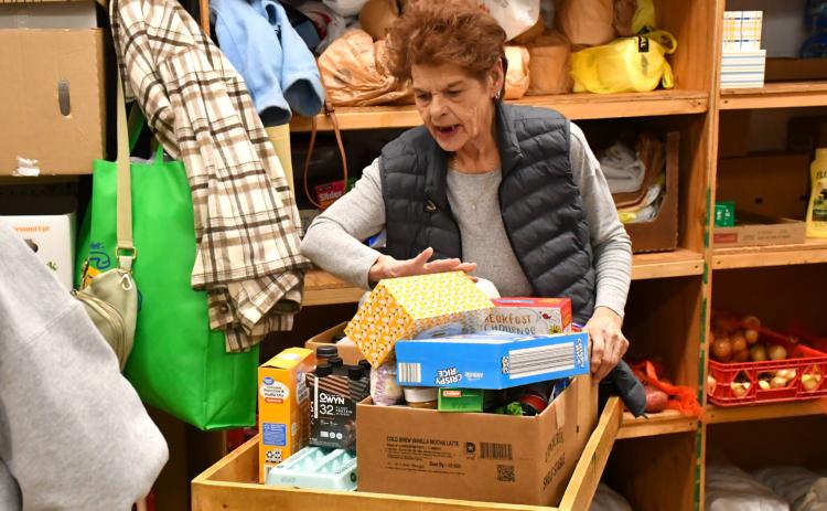 Bristol resident Joni Dolney loads up food for her neighbor at Day County Food Pantry Nov. 11 in Webster. Food pantry organizer Margaret Kwasniewski said the pantry has seen a slight increase in people served due to the government shutdown which resulted in a SNAP block. Reporter &amp; Farmer | Connor Handrahan