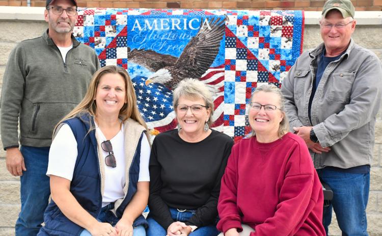 Some of the Roslyn Area Veterans Memorial commitee members pose in the partially completed park Nov. 4. Commitee members are, from back right, Danny Kjos and Terry Corner. Seated, from left, are Jess Simonson, Tamie Sattler and Shelly Deutsch. With a hopeful completion date in 2026 the memorial will contain plaques with names of deceased veterans from the Roslyn area and provide space for community events. Reporter &amp; Farmer | Leyton Beardslee
