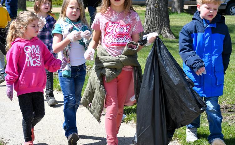 Members of Webster Area Elementary kindergarten class worked their way around town last week to clean up any debris they happened to find. The April 22 activities focused on Earth Day. Pictured from left are, Elyzabeth Gangle, Althea Cyrus (back), Harlow Heupel, Rylee Wik and Caleb Sonstebo. Reporter &amp; Farmer | Amanda Dulitz