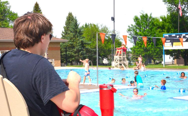 Thomas Kuecker, now with five summers of lifeguard experience, watches over swimmers in the afternoon sun on the first day of open swim at Webster Aquatic Center, June 1. Kuecker has made two rescues in his career, but said a typical day is spent enforcing the pool rules. Reporter &amp; Farmer | Timothy Gibson
