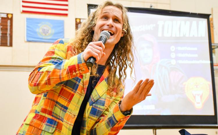 Motivational speaker Nick “Sunshine” Tokman sings during an assembly for Webster Area Middle and High School students Jan. 13 in the Webster Area High School gym. Tokman used his life experience as a professional fisherman on the Deadliest Catch TV show to discuss topics such as depression, low self-worth, discovering a career path and believing in yourself. Reporter &amp; Farmer | Leyton Beardslee