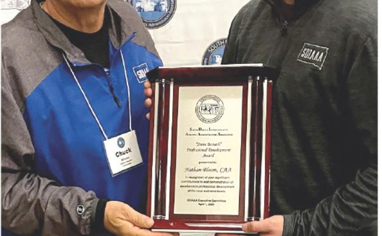From left, Todd County AD Chuck Wilson, president of the SD Interscholastic Athletic Administrators Association presented the Steve Berseth professional development award to Webster Area School AD Nathan Bloom at SDIAAA's annual conference in Chamberlain. Reporter &amp; Farmer \\ Subscriber snapshot