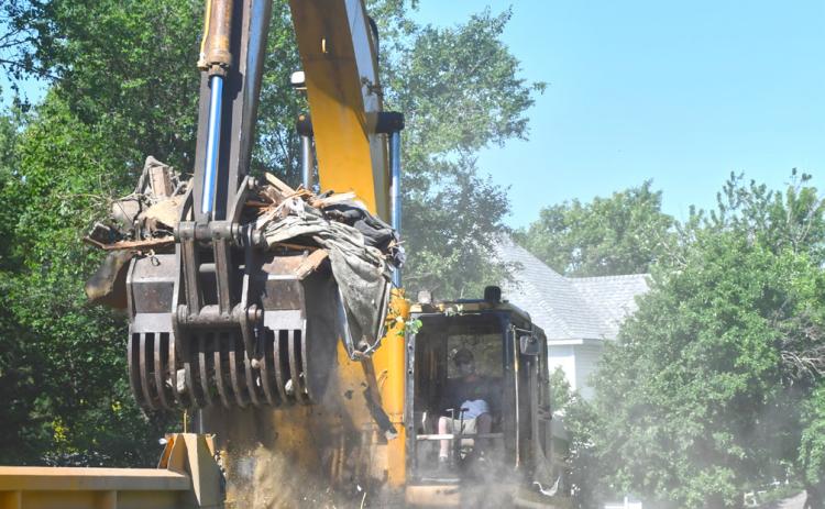 Rubble from the demolition of a house located at 1106 Main St., Webster is loaded into a dump truck June 24. The demolition comes after the city seized possession of the property in August 2024 and the building caught fire in September of the same year. An investigation was launched to determine if the cause of the fire was arson but the states attorney ruled there was not enough evidence to pursue charges and the building was demolished. Reporter &amp; Farmer | Leyton Beardslee