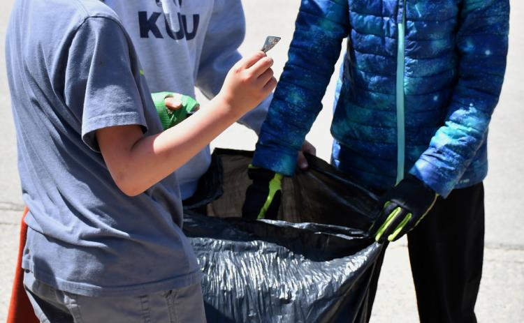 In honor of Earth Day, Webster Area Elementary students hit the streets of Webster to clean up any trash they found. Here third graders Odin Brockhaus, Hunter Ruff and Beckett Matthews assist in the endeavor April 23. Reporter &amp; Farmer | Leyton Beardslee
