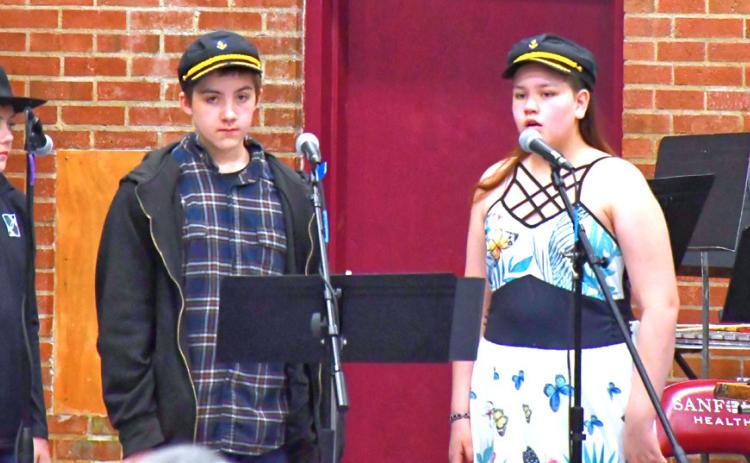Webster Area Elementary put on their spring music concert April 20. The theme was based around western ideas and kids dressed up looking ready for the ranch life. From left, Oakley Ascher, Lucas Breaw and Piper Sichmeller introduce the next song. Reporter &amp; Farmer | Connor Handrahan