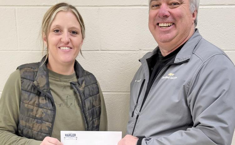 Webster Area School nurse Heather Gaikowski receives a check presented by Loren Schoenbeck on behalf of Dave Hahler Automotive in Webster Nov. 26. The $2,100 donation will to towards assisting students in need of winter clothing. Reporter &amp; Farmer | Subscriber snapshot