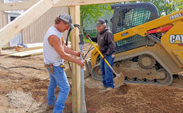 Rock is stamped around posts May 28 as construction begins for an addition to the Museum of Wildlife, Science &amp; Industry in Webster. Pictured from left are Chris Amundson and Greg Johnson. Reporter &amp; Farmer | subscriber snapshot