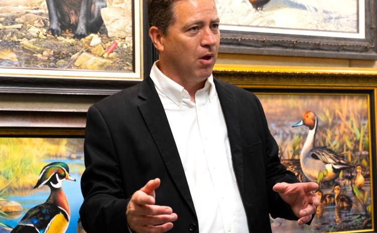 Adam Grimm, surrounded by his artwork, talks to attendees of his hometown celebration in Wallace Aug. 9 about winning the 2024-2025 Federal Duck Stamp Art Contest. This was Grimm’s third time winning the contest but first time holding a celebration in Wallace which included bouncehouses, educational games, coloring contests and displays of Grimm’s art. Reporter &amp; Farmer | Leyton Beardslee