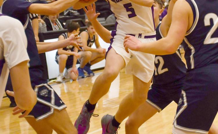 Waubay-Summit Mustangs faced off against Great Plains Lutheran Panthers Feb. 20 in Summit which ended in a 57-47 victory for the Mustangs. Here, Dylan Rumpza (5) attempts to distribute the ball while a claw of Panthers surround him. Reporter &amp; Farmer | Brenner Cariveau