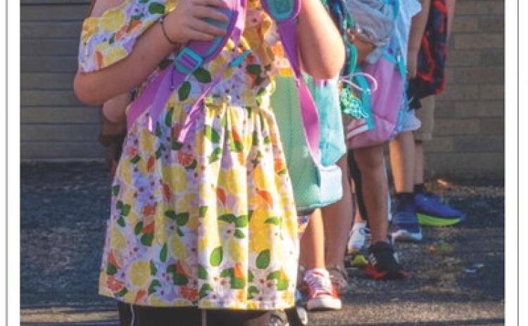 Alena Carlson, age five, daughter of Justin Carlson and Abbie Carlson of Webster lines up for her first day of school at Webster Area Elementary School Aug. 19. Reporter &amp; Farmer | Leyton Beardslee