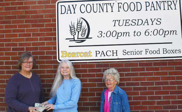 The Day County Food Pantry received a donation of funds from the first annual Chuck Aleck Memorial event. The memorial event was conducted by Bondell Raeder-Aleck Sept. 15 and saw contributions from attendees which totaled for over $1,300 in cash and giftcards. Here, on the left Margaret Kwasniewski is given the funds received from Raeder-Aleck and to the right is Carol Richardt.