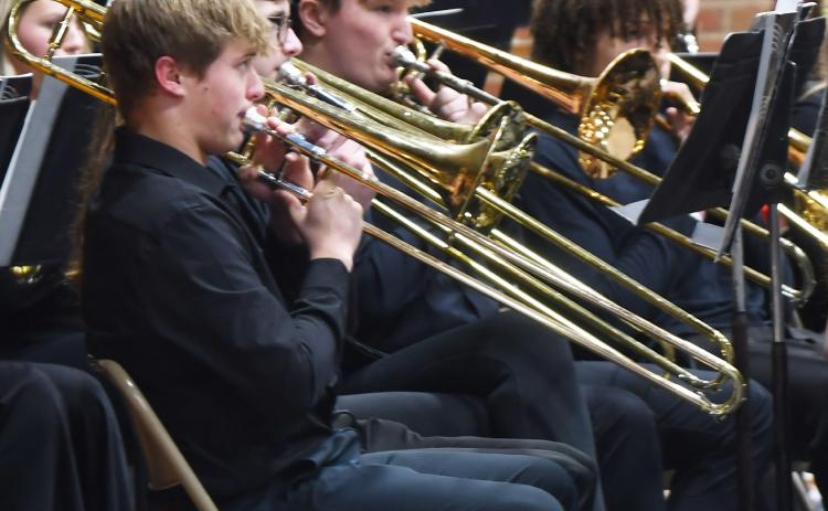 Webster Area Middle School and High School students performed in the winter conert Dec. 5 at the Webster Armory. Here, high school band members in line Michael Dorsett, Lukas Johnson, Thomas Kuecker and Mason Huwe play the trombone as a part of the concert. Reporter &amp; Farmer | Brenner Cariveau