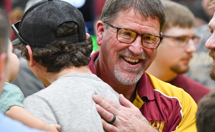 Webster Area head wrestling coach Wade Rausch is congratulated by former wrestlers after being selected as Region 1 coach of the year at SDHSAA Region 1B wrestling tournament in Webster Feb. 21. Rausch has announced his retirement at the end of the school year with his final wrestling meet being the SDHSAA State Wrestling Championship in Sioux Falls Feb. 26-28. Reporter &amp; Farmer | Leyton Beardslee