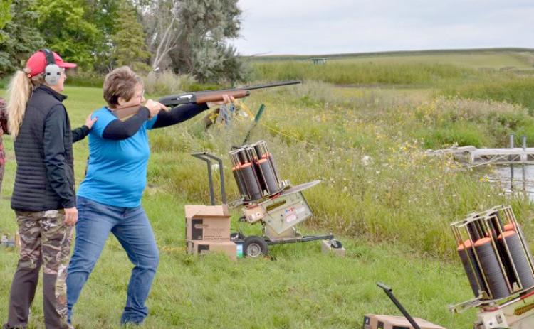 Tina Dokken steadies Shannon Garduno’s shoulder during a target practice session at last year’s event to learn how to pheasant hunt at Lynn Lake. Reporter &amp; Farmer | Subscriber snapshot
