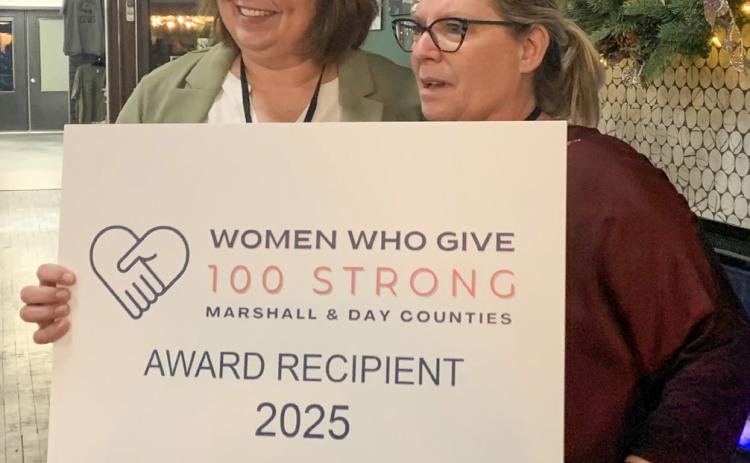 Jennifer Roerig presents the top 100 Strong of Marshall and Day counties award to Marie Marlow of the Marshall County Food Pantry during the first annual Women Who Give event Dec. 2 held in Webster. Five non-profits were in the running for the top prize, this year equating to $9,000. Each of the other four charities received $925. In total, the event saw 117 women register and raised $12,700. See more: 14. Reporter &amp; Farmer | Amanda Dulitz