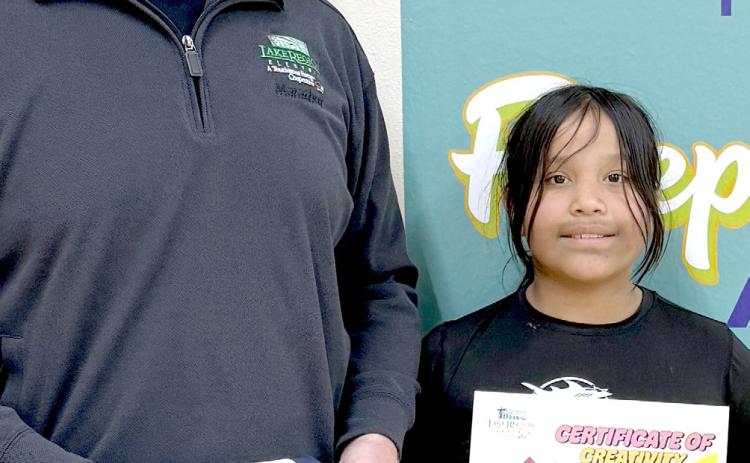 Webster Area School student Lydia Williams, right, was chosen water bottle label design contest winner by Lake Region Electric (LRE). This was the first year that LRE did a water bottle label contest. In the past, they have donated bottled water to the school to use at events and fundraising opportunities. This year they involved third grade students to help educate about electrical safety. Reporter &amp; Farmer | Subscriber snapshot