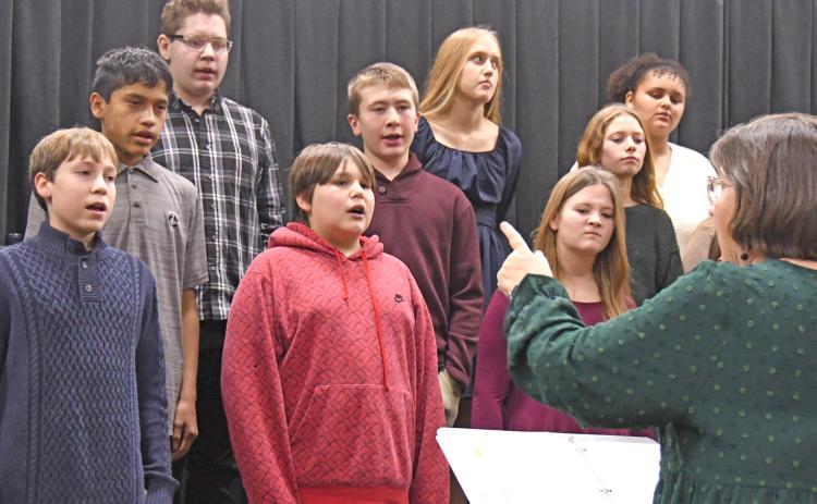 Members of the Waubay Middle School chorus performed Dec. 9 for their Christmas concert. Pictured from left in back are, Tyson Utne, Elise Aker and Kaliesha Neilan; middle row, Victor Vermillion, Conner Butler and Riley Pies; in front are Kellin Boik, Ayden Eagle and Rynsey Jorgenson. The performers were directed by Jill Beers, pictured at bottom right. Reporter &amp; Farmer | Amanda Dulitz