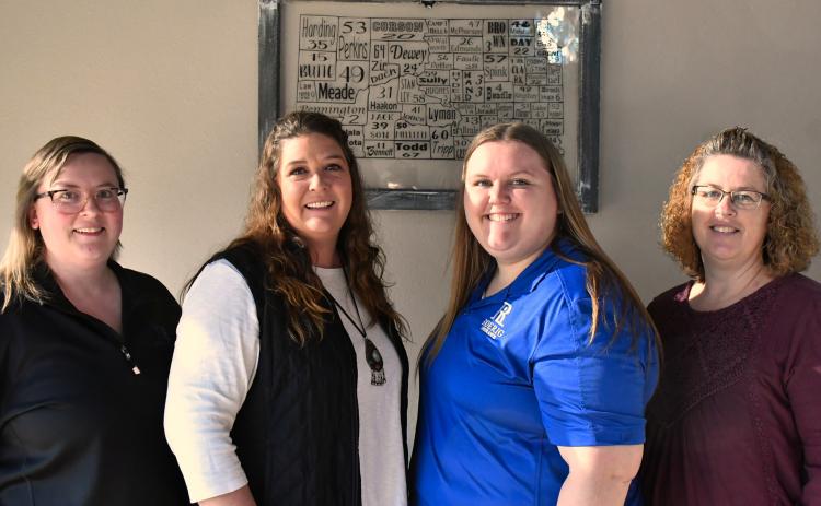 Standing in the Roerig Insurance office lobby are Webster team members Brooke Smidt, Katy Marx, Kayla Kirchmeier, Amy Fischer.