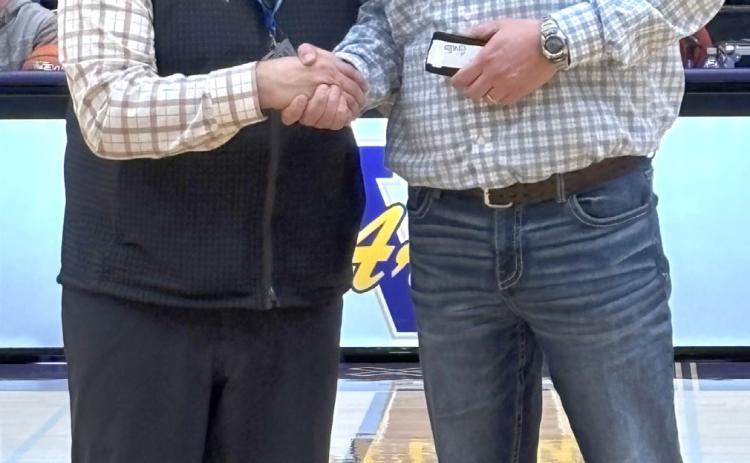 Webster Area third grade teacher and former basketball coach Jared Vergeldt, right, receives his 25 year coaching award from SDHSAA executive director Dan Swartos during halftime of a State A girls basketball tournament game in Watertown March 13. Vergeldt began coaching for the Bearcats in 1997 and spent time coaching boys and girls basketball, track, cross country and volleyball. Reporter &amp; Farmer | Subscriber snapshot