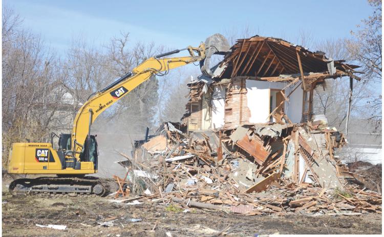 A house and garage at 909 E. 1st Street in Webster was demolished April 8. Webster City Council approved the removal poration, which included allowing the debris from the structures to be hauled to the city dump for disposal. permit request by Webster Area Development Cor- Reporter &amp; Farmer \\ Amanda Dulitz
