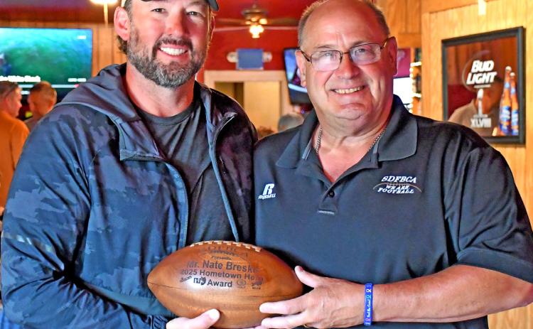 Nathan Breske was presented the Hometown Heros Award from the South Dakota Football Coaches Association July 7 by association representative Bill Weber. Here, Breske is shown with Weber at the Longbranch Bar in Grenville where the award presentation took place in front of family and friends. Reporter &amp; Farmer | Amanda Duitz