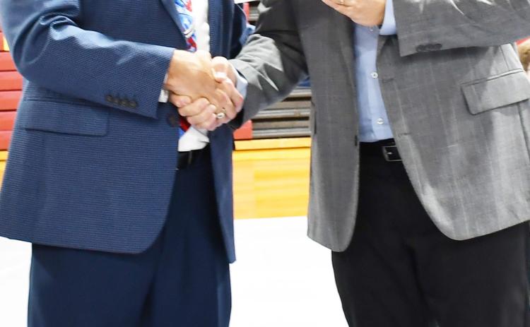 As a Veterans Day celebration was held Nov. 11 at Webster Armory, numerous events took place including choirs, essays and a military ceremony. Here Webster Area School Superintendent Jim Block left shakes hands with Jeff Nelson, Day County Veterans Service Officer after presenting a check worth $700 as the Veterans Day event ended. Reporter &amp; Farmer | Brenner Cariveau