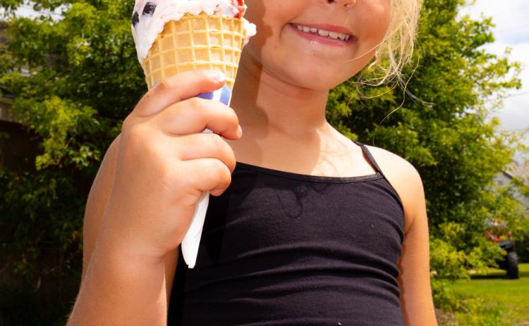 Naomi Lesnar, age eight, daughter of Marlaina and Christopher Kinn from Grenville holds up her ice cream cone July 19 at Waubay Fun Fest. The festival ran July 18-20 and included events such as a cornhole tournament, live music and a parade. Reporter & Farmer | Leyton Beardslee