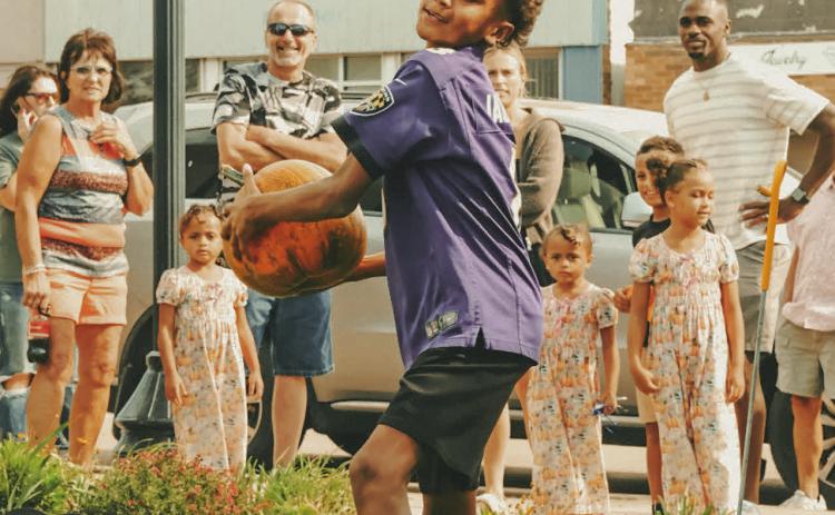 Riley Young, age 10, competes in a pumpkin ‘chunkin’ contest to see who could throw the gourds the furthest distance during Pumpkin Fest in Webster Oct. 4. Young is the son of Karrie and Martevious Young of Sioux Falls. See more on 11. Reporter &amp; Farmer | Leyton Beardslee