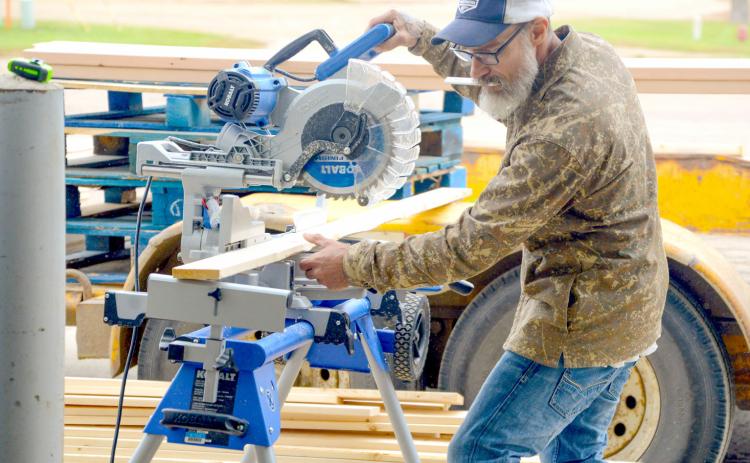 Shawn Andres is a newcomer the Sleep in Heavenly Peace Sisseton chapter who was on scene at Waubay last weekend for a bed build event. Here, he helps measure and cut 2x4s for the other volunteers to use to start building beds. Reporter &amp; Farmer | Connor Handrahan