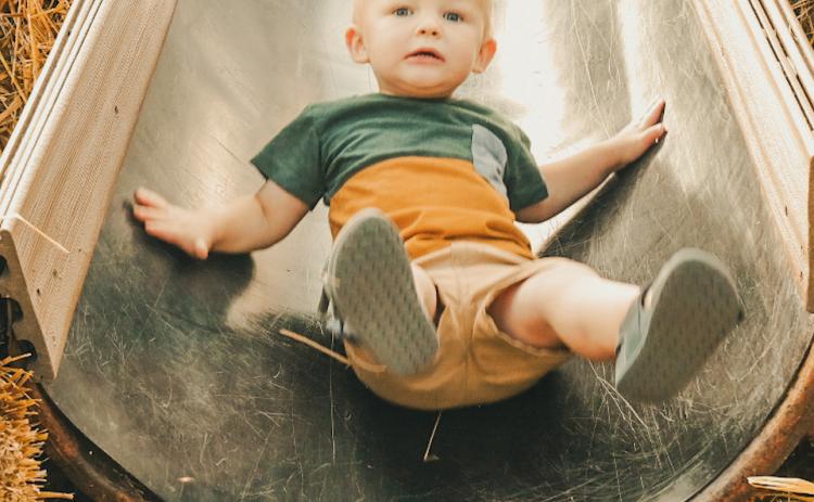 Fisher Kimble, age one, rides down a slide during Pumpkin Fest in Webster Oct. 4. He is the son of Huxley and Kali Kimbol from Watertown. Reporter &amp; Farmer | Leyton Beardslee