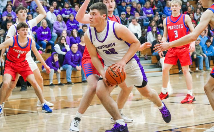 Tripp Gaikowski of Waubay/Summit Mustangs drives towards the hoop through defenders during their 51-36 victory over Hitchcock-Tulare Patriots in the Region 1B quarterfinals March 3 in Waubay. Gaikowski totaled six points in the win and the Mustangs advanced to take on Leola/Frederick Titans March 6 which was not completed in time for results to be published. Reporter &amp; Farmer | Leyton Beardslee