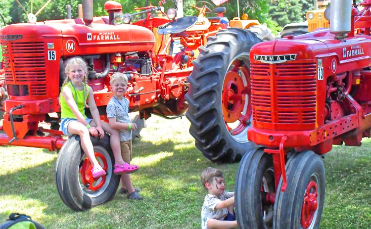 Waubay Fun Fest was July 17-18. WIth Main Street full of festive fun, one entertaining area was where the antique tractors were parked. From left, Peyton and Finn Frank and Tommy Kampa play around the tractors and enjoy seeing the machines close up. See more on 7. Reporter &amp; Farmer | Connor Handrahan