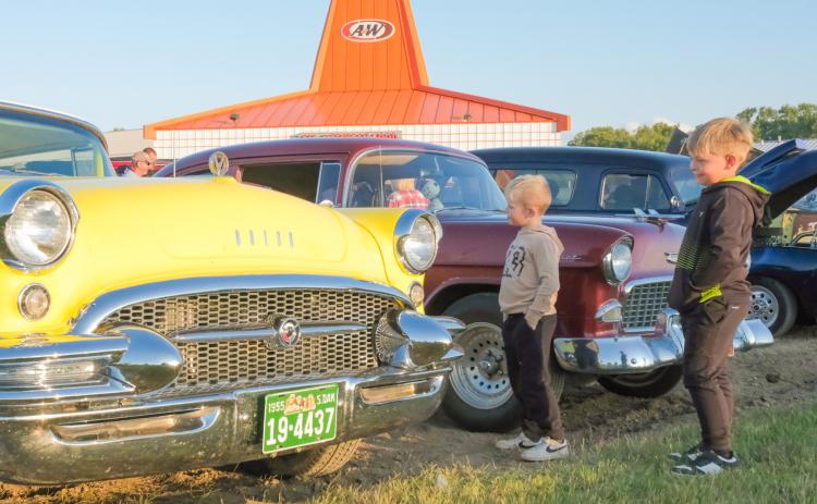 A&amp;W celebration attendees, from left, Grady Tvinnereim, age six, son of Missy Rumpza and Derek Tvinnereim from Webster, and Hayes Spiering, age six, son of Chris and Sarah Spiering of Webster, look at a 1955 Buick during a car show celebrating the A&amp;W restaurant in Webster Sept. 3. Plans were announced earlier this year for the building to be replaced with an updated A&amp;W restaurant. Reporter &amp; Farmer | Leyton Beardslee