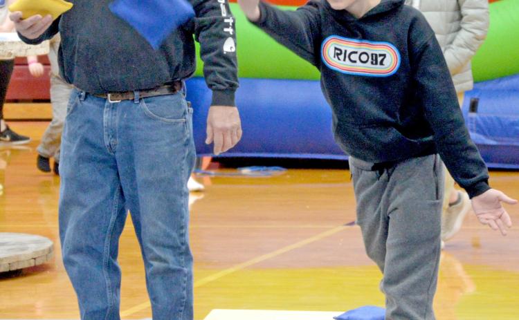 Participating in the Shake Your Shamrock cornhole tournament March 15 at the Webster Armory are Toni Brown and Oakly Ascher. The event was held as a fundraiser for the Webster-Dewangen German student exchange group. Reporter &amp; Farmer | Amanda Dulitz
