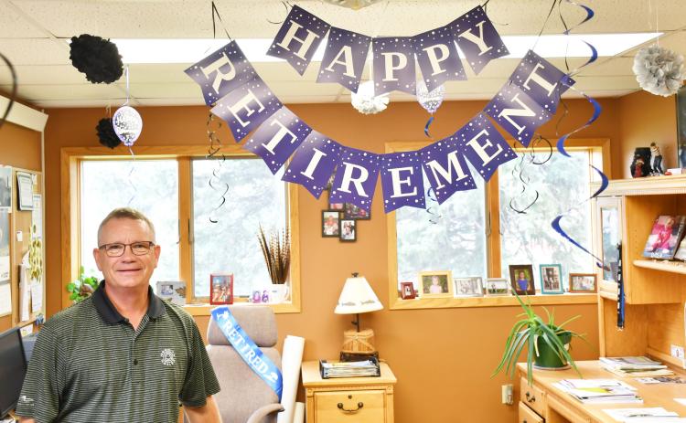 Lake Region Electric manager Tim McIntyre stands next to his decorated office which celebrates his upcoming retirement Sept. 3. Reporter &amp; Farmer | Brenner Cariveau