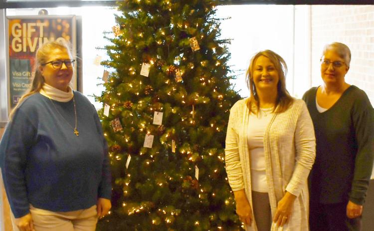 The Spirit of Christmas tree is giving joy to less fortunate children. Tags to donate presents for children can be found at Dacotah Bank, CorTrust Bank and First Interstate Bank in Webster. Here, from left volunteers Teresa Mikkelsen, Stacy Mount and Marla Althoff stand next to the Spirit of Christmas tree located in Dacotah Bank Dec. 4. Reporter &amp; Farmer | Brenner Cariveau