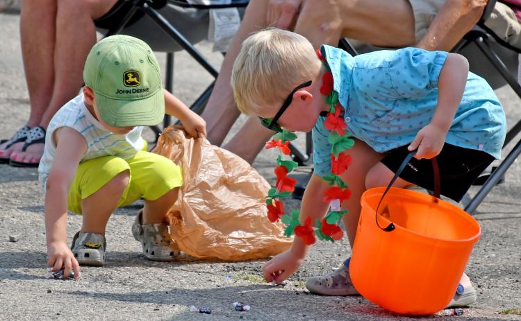 Kash Hoven, two, and Hayes Spiering, five, scramble to collect as much candy as they can during the Waubay Fun Fest parade July 20. Hoven is the son of Josh and Lauren Hoven of Webster, while Spiering is the son of Chris and Sarah Spiering, Webster. Reporter &amp; Farmer | Amanda Dulitz